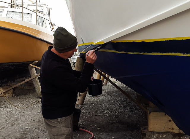 Photo of Phil painting the boot top line