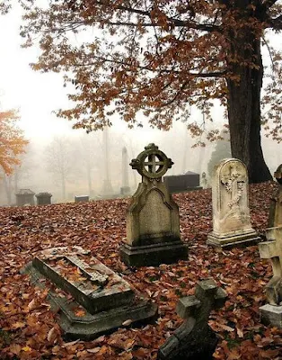 A grave in autumn with falling leaves...