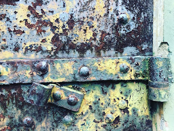 iron door, layers of peeling paint and rust