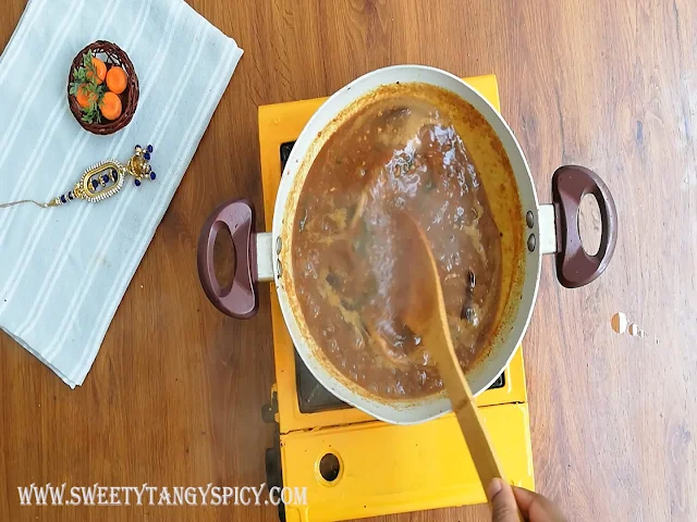 Jaggery syrup being mixed thoroughly with the ginger-tamarind mixture, followed by tasting and adjusting salt and spices to achieve the perfect balance of flavors in the Inji Puli chutney.