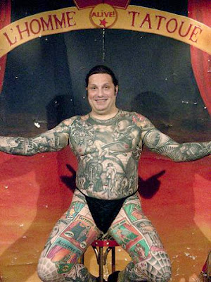 Body Art Tattoo Comic story tattooed on fat man's body .
