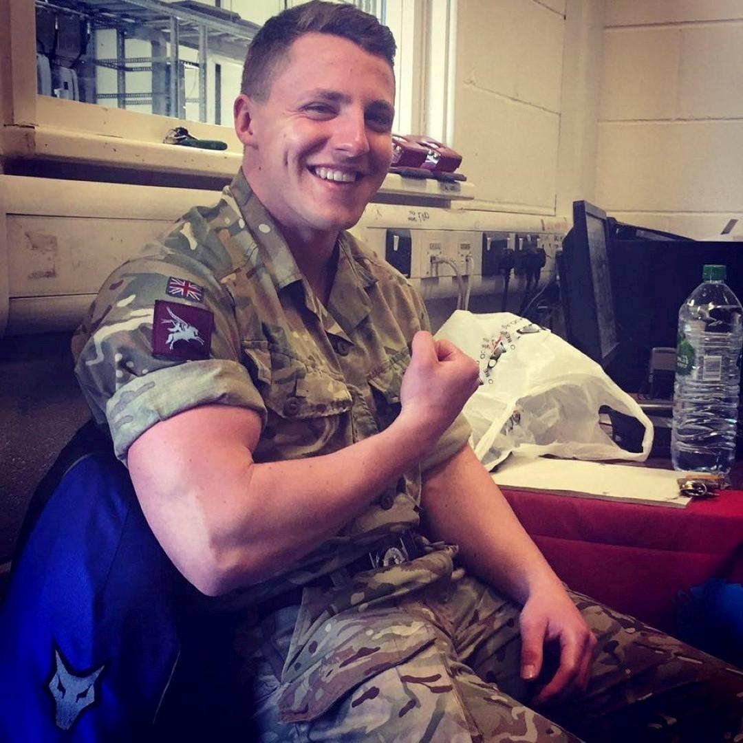 cute-beefy-smiling-british-military-uniform-soldier-biceps-flex