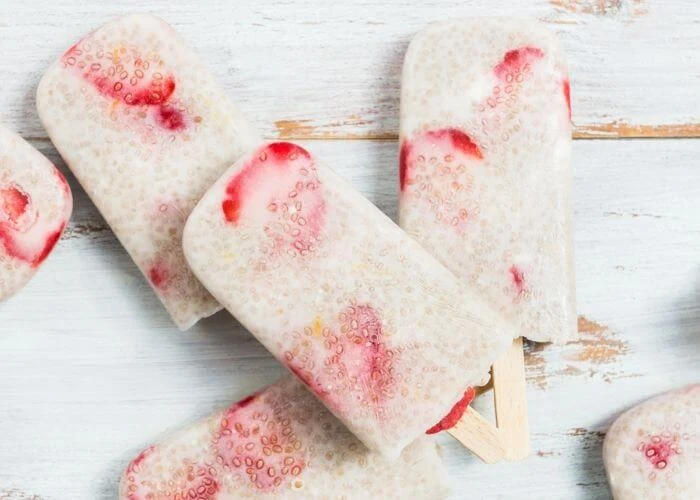 How to make strawberry chia seed popsicles recipe. This clean eating ice pops are made with strawberries and coconut milk or almond milk. They are low calorie with honey or maple syrup.  Make these healthy popsicle for kids this summer.  Simple homemade sugar free berry chia seed pops. Healthy recipes with fruit.  Diy vegan and easy chia seed recipe. #strawberry #chiaseed