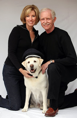 Lorrie and Sully Sullenberger with Twinkle wearing pilot's hat