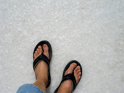 Feet standing on salt bed, Inagua, Bahamas.