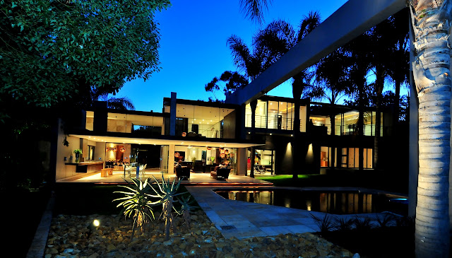 Picture of the house as seen at night from the area behind the swimming pool