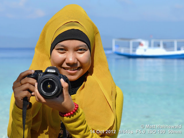 street portrait, Indonesia, Central Sulawesi, young Indonesian Muslim lady, photographer, yellow hijab, beach, Nikon DSLR D3200, charming, outgoing, smiling