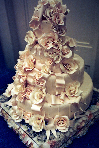 Romantic 4 tier round wedding cake in ivory with an enormous amount of sugar