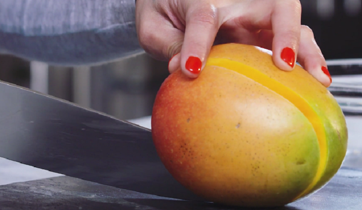 Woman cutting a mango