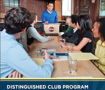 Image of Toastmaster Brochure with a man standing at lecturn and members listening to his advice