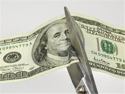 Scissors cutting money