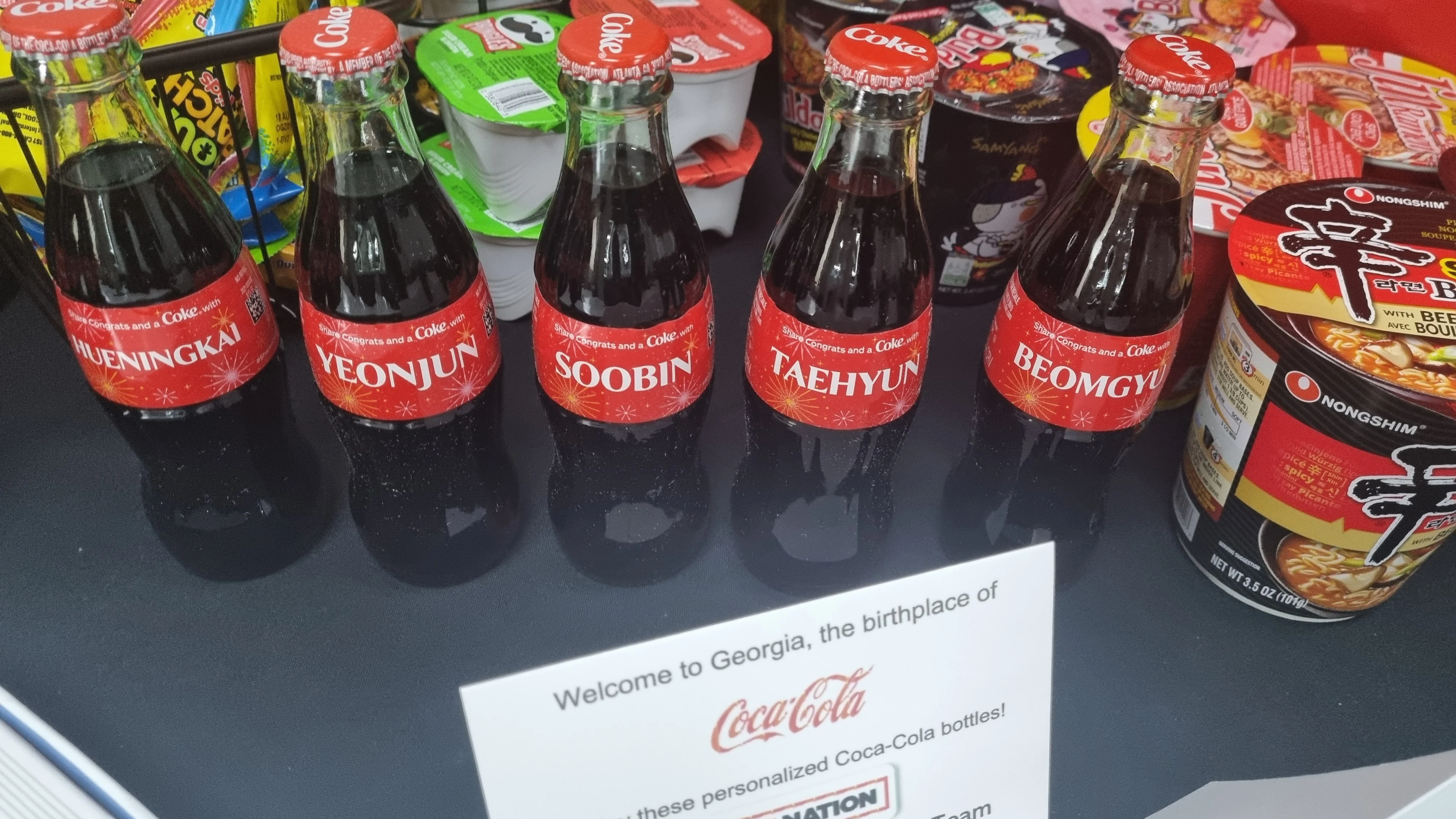 Taehyun's Weverse post: Coke Bottles with their names on it from the original Coca Cola Factory in Atlanta, GA.