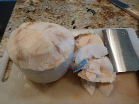 Step 2: Shave off the top third of the husk of the coconut