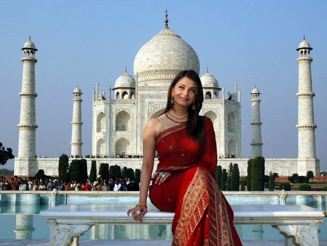 Miss World and queen of hearts - Aishwarya Rai poses in front of Taj Mehal in a red Saree