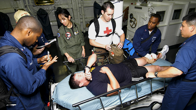 The medical response team aboard multi-purpose amphibious assault ship USS Wasp (LHD 1) prepares to treat Petty Officer 1st Class Jeremy Sylvest, a Navy diver of the Norfolk-based Mobile Diving Salvage Unit 2 during a Diver Medical Evacuation exercise. The Navy's diving medical officers conduct physicals, diver injuries, and treat serious dive-related injuries while representing the Navy's diving community. (Photo credit: Chief Petty Officer Jeremy Siegrist)