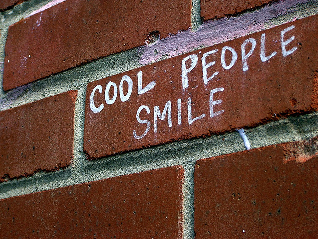 cool-people-smile-written-with-chalk-on-brick-wall