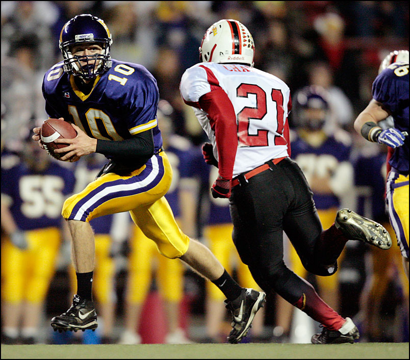 Kewaunee High School quarterback Doug Delebreau (10) is pressured by 