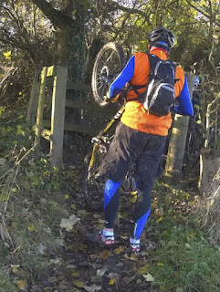 Mountain bike cycling, through a gate