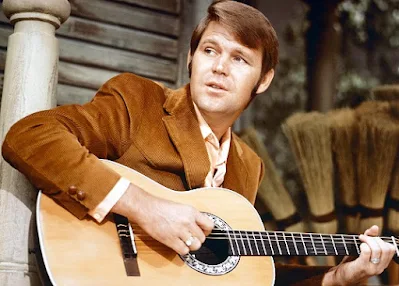 Glen Campbell, de Grande Musico de Estudio a Ícone do Country Rock, um artista versátil que deixou sua marca na história da música.