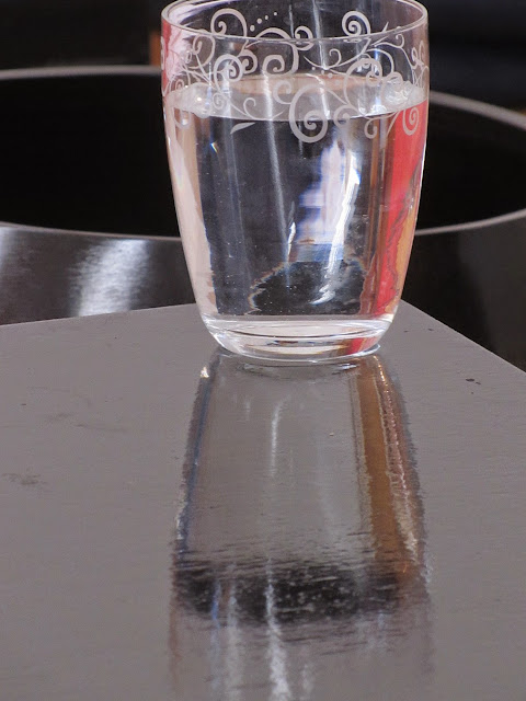 glass of water on a smooth black surface