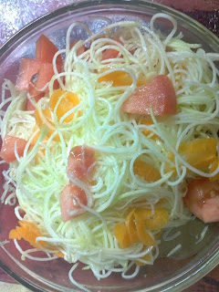 Veggies mixed in bowl: zucchini, carrots, and tomato