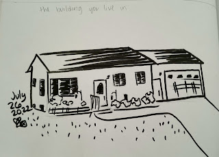 A loose pen drawing in a sketchbook of a ranch style house with attached garage.