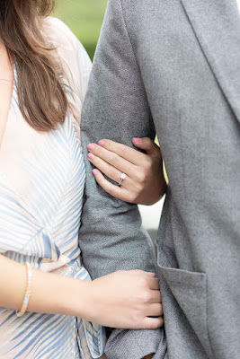 couple linking arms with engagement ring