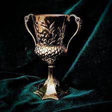 It shows the yellow color Hufflepuff's Cup in dark background.