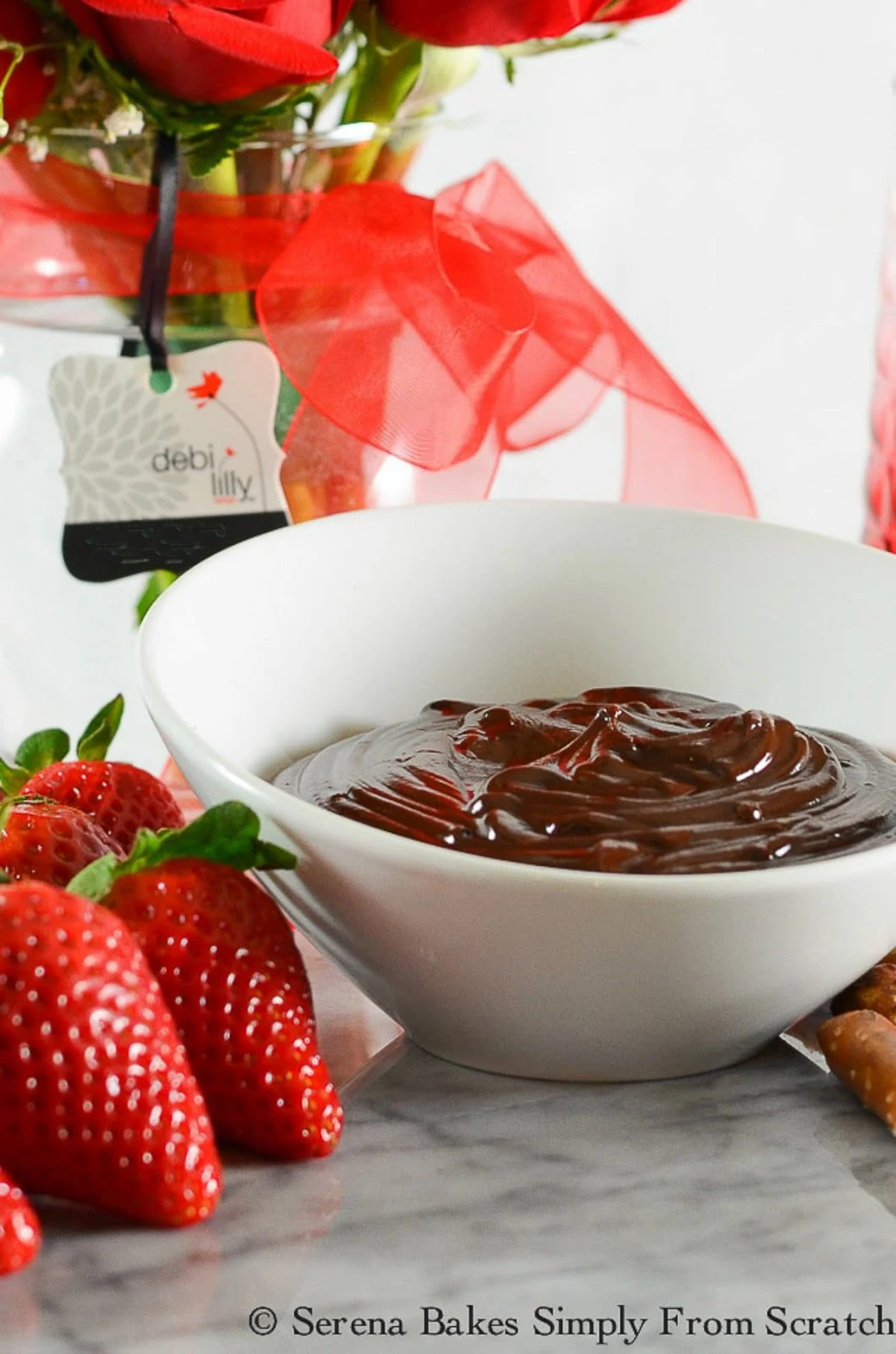 Hot Fudge Chocolate Fondue with strawberries and pretzel rods for dipping is a perfect dessert for Valentines Day or Easter from Serena Bakes Simply From Scratch.