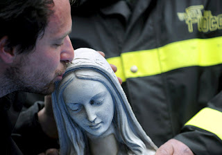 Fireman Kissing Head of Statue of the BVM