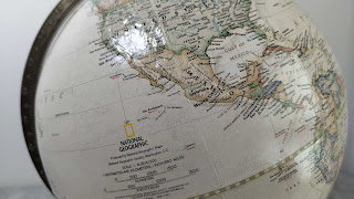 The raised relief and the National Geographic logo on the globe