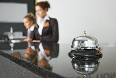 a bell sits on the hotel desk to symbolize customer service