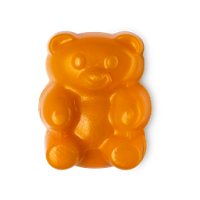 A photo of a orange gummy bear shaped shower jelly on a bright background