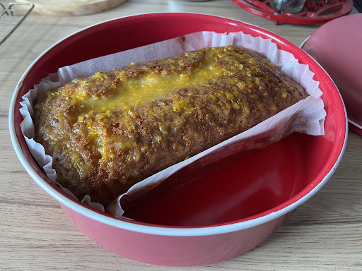 A close up of a homemade orange and blueberry cake