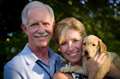 Sully and Lorrie Sullenberger with yellow Lab pup