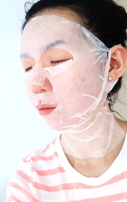 Michelle's sheet mask selfie, side view.