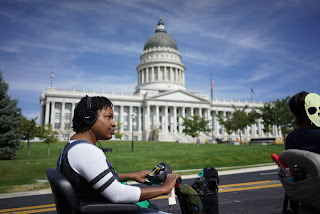 Person using a wheelchair in front of a capitol building