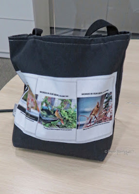 This photo features one of  the tote bags I have designed. The one here has a has a black background and is sitting on a table.  The item is made of poly-poplin.  My totes come in three sizes (13” by 13," 16" by 16," and 18" by 18") each item the one seen here is 13” by 13.”  Each tote includes a one inch strap for easy carrying on your shoulder. All seams are double stitched for added durability. These are machine washable (in cold water) and the same image (in this case that image is of the book jackets for my three volume book series, “Words In Our Beak.”**) is printed on both sides.  *Info re this tote is @ http://bit.ly/2UlBrRU **Info re these books is @ http://bit.ly/2EdADpx