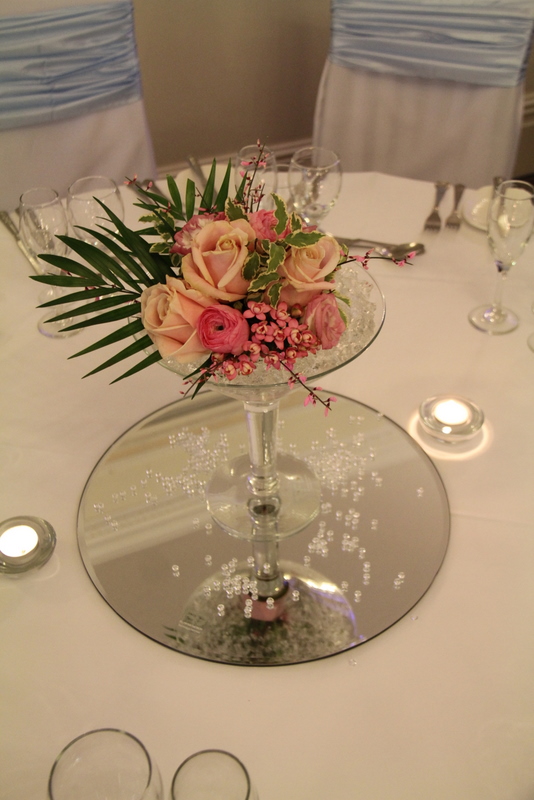 This low but oversized clear glass Martini vases complete with a fresh 