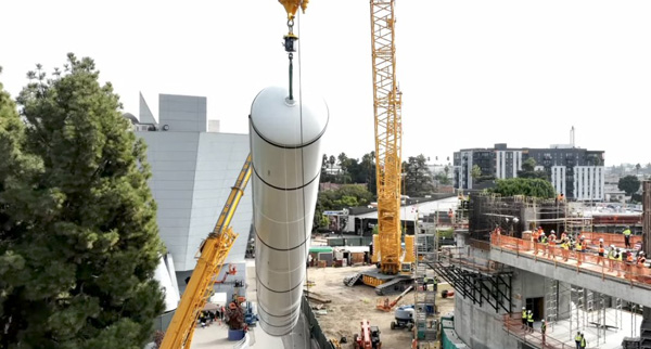 The first of two solid rocket motors that will form the backbone of Endeavour's completed space shuttle stack is rotated into vertical position before it is moved to the construction site for the Samuel Oschin Air and Space Center in Los Angeles...on November 7, 2023.