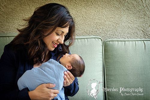 Professional portrait of a newborn baby and family outside