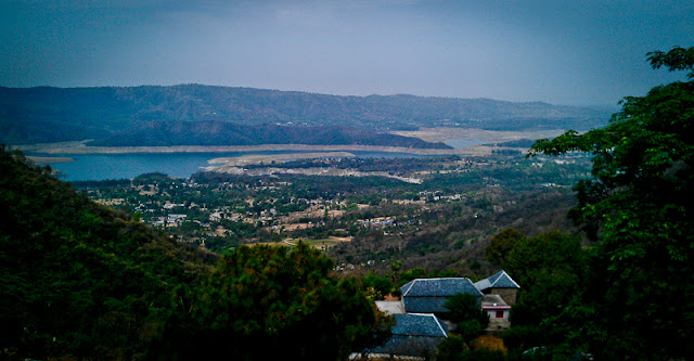 Mobile-Giri from a bus near Govind-Sagar Lake @ Lathiani, Una, Himachal Pradesh !!! :  Posted by VJ SHARMA on www.travellingcamera.com : The reservoir on the river Sutlej which was formed after the hydel dam at Bhakra was constructed and has been named in honour of Guru Gobind Singh, the 10th Sikh guru. Gobind Sagar Lake is spread over different parts of Bilaspur and Una districts of Himachal Pradesh...This time I was going to Ludhiana in a bus and thought of clicking some photographs of Gobin Sagar Lake with my new HTC Dezire HD. Gobin Sagar Lake comes on the way when we move towards Una/Chandigarh from Hamirpur... Also it comes on the way when we move to Chandigarh from Hamirpur/Mandi/Kullu/Manali via Bilaspur. So I always see this lake whenever I go my Home from Delhi :)Water level this time was very low... I have seen this lake many times in summers, but this time it was rarely visible due to very low water level.There is very clear view of Gobind Sagar Lake, when we cross a small town called Barsar. Aftr crossing Barsar, we climb up a hill and then a downhill starts till Lathiani. This is the stretch when lake is visible...In the months of October and November water level of the reservoir goes high and a series of regattas are also organised by the Tourism and Civil Aviation department... Water-skiing, sailing, kayaking and water scooter racing are popular water sports activities during this period.Major attractions of the lake include ferry rides and water sports like speedboating.Two years back, roads near this lake were very risky and narrow. This time I was really happy to see smooth and wide roads...Gobind Sagar was declared as a water fowl refuge in 1962. Fishing is commonly practiced here. It has about fifty one species and sub species. Labeo dero, Tor pitutrata, Mystus seenghala and Mirror carp are some of the common species found here.During summers some part of the lake is completely dry and look like Sholey's location where Gabbar used to stay with his gang !! Rocks and sand without any tree or grass !!! I rarely find time to plan one day trip to this place during summers. Hope to go their soon ! Many punjabi movies are shot near this lake...In Bilaspur, many temples can be seen at the ground level during summers. These temples belongs to the times of king of Bilaspur and  after monsoons they get covered by water !!!