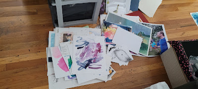 a pile of old, unfinished art on the floor.
