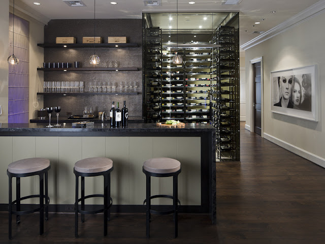 Photo of dark kitchen with island and bar chairs