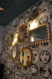 Combinations of small mirrors or asymmetric mirrors unusually small or large seek to attract attention