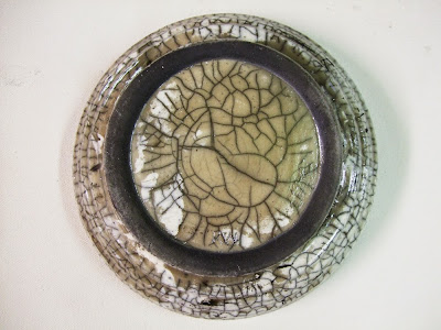 Image of underside of white crazed ceramic raku dish
