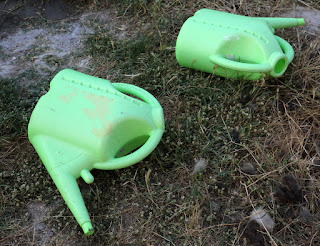 Two tired watering cans