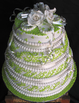 The above fourlayer cake with white roses was made for a couple