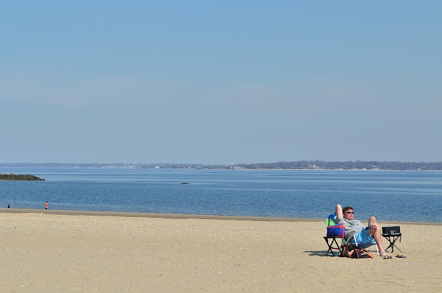 A man listens to the Yankees on Orchard Beach in the Bronx, NY.