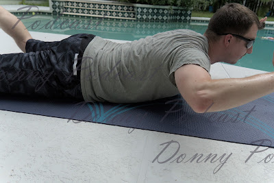 man doing skydiver exercise at the pool side